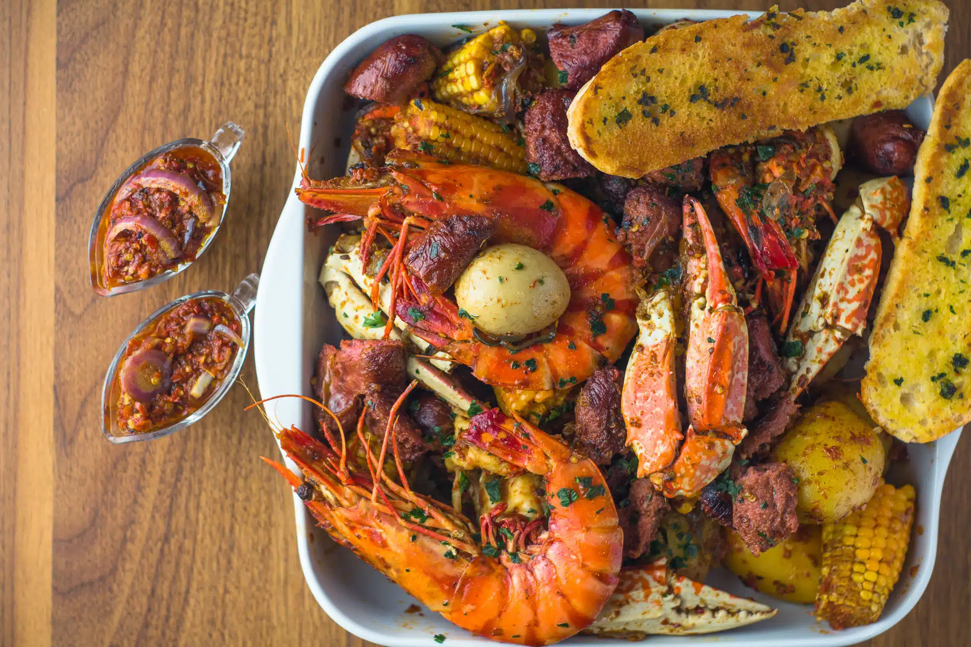 Seafood platter with shrimp, crab, corn, potatoes, and bread at M&M African Kitchen